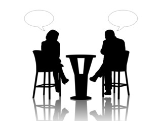 man and woman speaking at the table in a cafe