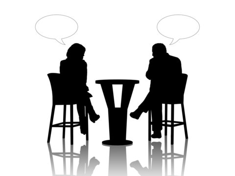 man and woman speaking at the table in a cafe