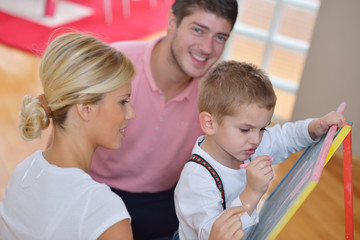 family drawing on school board at home