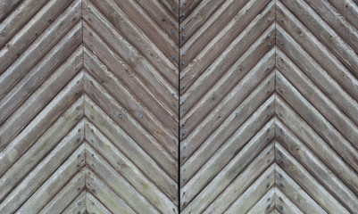 Old wooden gate with pig-iron rivets as a background
