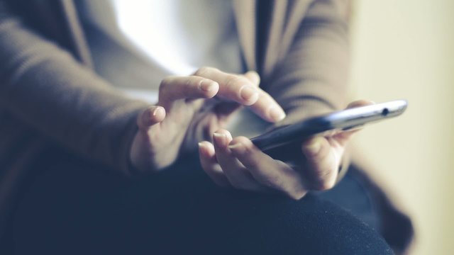 close up of hands woman using typing on smart phone cellphone 