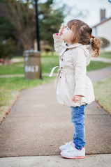 Fototapeta premium Cute fashionable baby girl smiling outdoors