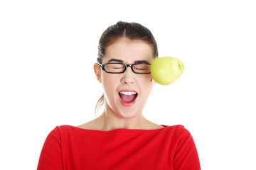 Casual woman in glasses hit by apple