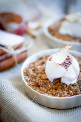 Apple crumble dessert with cinnamon and vanilla ice -cream on wo