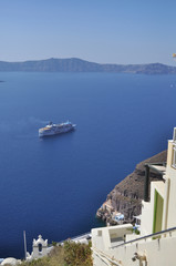 Ship in the Aegean sea near the rocks on the shore of the island