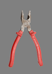 red pliers on a gray background