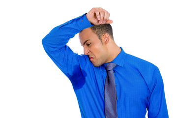 Closeup portrait of young man, smelling, sniffing his wet armpit