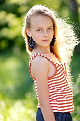 portrait of little girl outdoors in summer