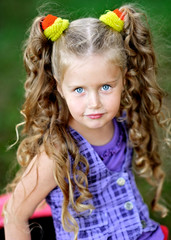 portrait of little girl outdoors in summer
