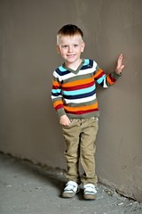 portrait of little stylish boy outdoors