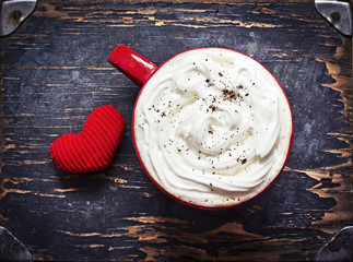 Red Cup of coffee with whipped cream and little heart