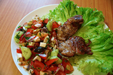 Meat and salad home food on a white plate
