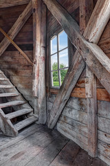 Interior of an abandoned wooden house with staircase