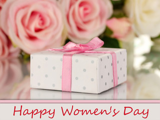 Beautiful gift on flowers background isolated on white