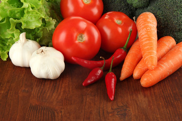 Composition of different vegetables on wooden background