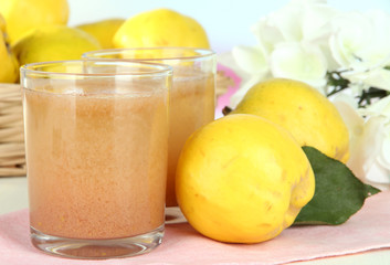 Sweet quince with juice on table on light background