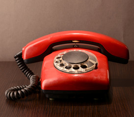 Red retro telephone,on dark background