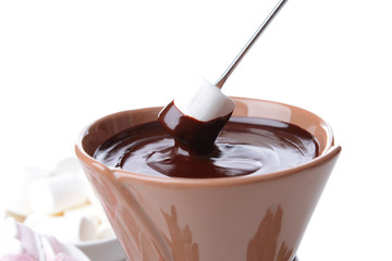 Chocolate fondue with marshmallow candies, isolated on white
