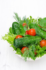 bowl with fresh vegetables and herbs for salad vertical close-up
