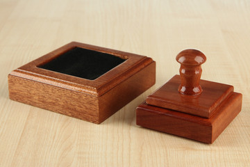 Wooden stamp on wooden background