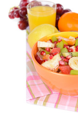 Sweet fresh fruits in bowl on table close-up
