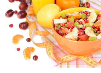Sweet fresh fruits in bowl on table close-up