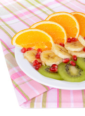 Sweet fresh fruits on plate on table close-up