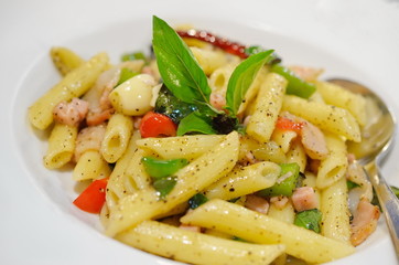 Penne pasta with ham and basil, Italian food.