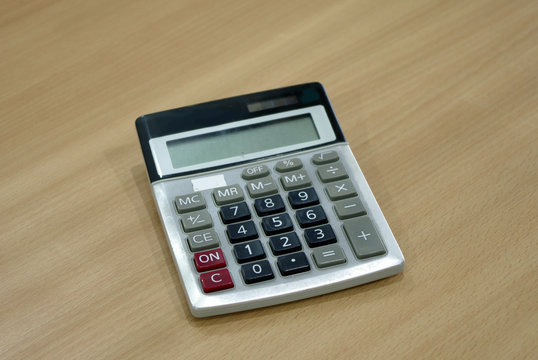 calculator on wood tablecalculator on wood table