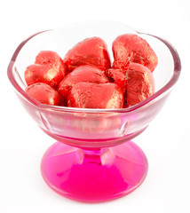 Сhocolate hearts in a vase isolated on white