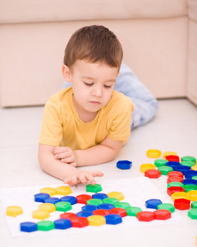 Boy is playing with building blocks