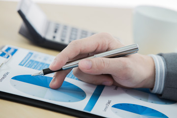 graphs and charts analyzed by businessman