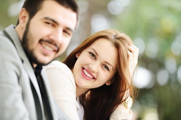 Lovely couple enjoying fall in love at park