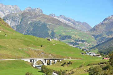 Fototapeta na wymiar Bridge over mountain river. Furka pass, Switzerland