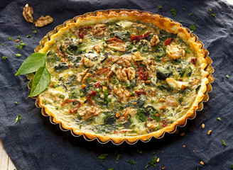 Spinach quiche with the addition of sun dried tomatoes and nuts