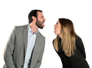 Couple sticking out her tongue over white background