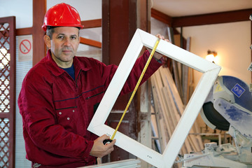 Portrait Of A Worker Using A Tape Measure