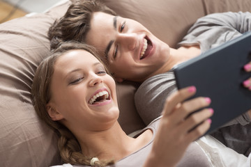 Obraz na płótnie Canvas Happy Couple with digital tablet