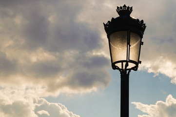 Antique lamp silhouette with clouds
