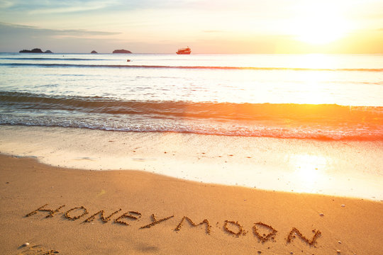 Honeymoon the inscription on the beach sand.