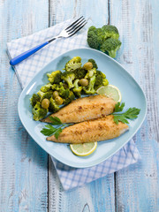 breaded fish with broccoli and olives