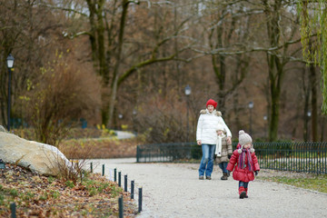 Fototapeta premium Two sisters and their mom in autumn park