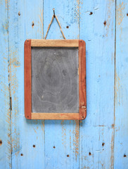 blank old black board, on weathered wooden wall,free copy space