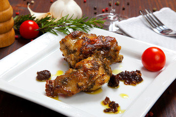 baked rabbit with tomatoes in a dish