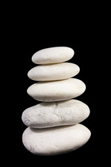 Pyramid of stones on black background.