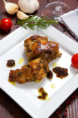 baked rabbit with tomatoes in a dish