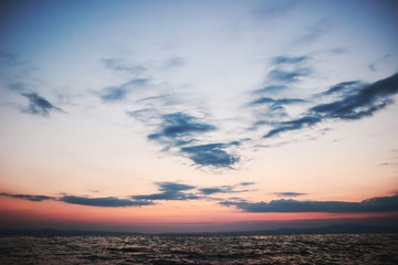 Naklejka na ściany i meble Beautiful tranquility sunrise over sea with cloudscape
