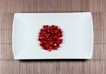 Pomegranate seeds on a rectangular plate