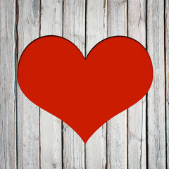 Obraz na płótnie Canvas Heart carved on a wooden surface
