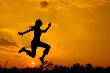 woman  jumping on the nature of the evening